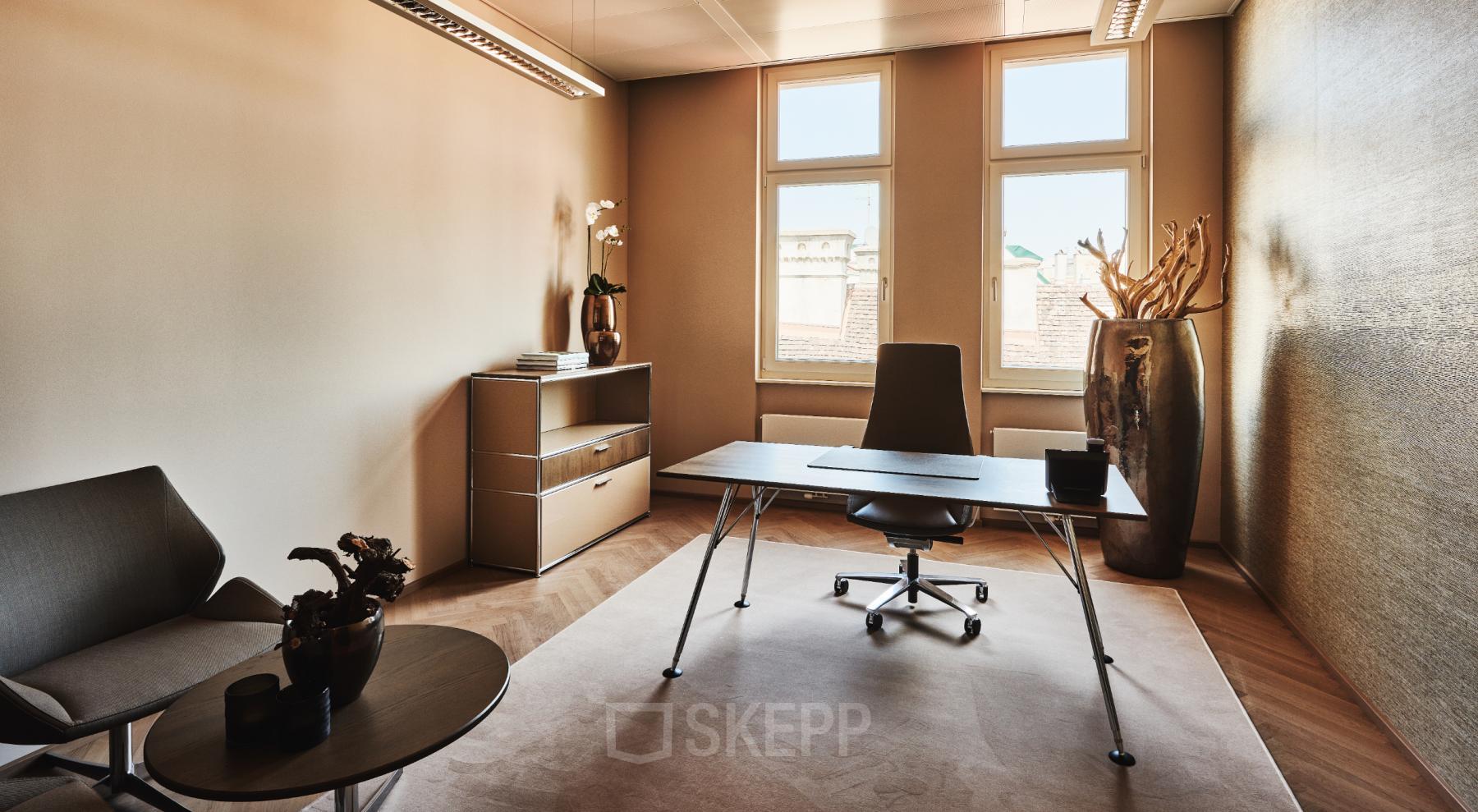 Elegant office space rental at Tuchlauben 7a, 1010 Vienna featuring modern desk, comfortable seating, and ample natural light.