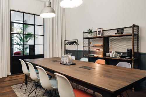 Elegantly appointed office space rental at Postgasse 8, 1010 Vienna, featuring a large wooden table, comfortable seating, and tasteful decor.