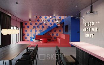 Vibrant office lounge area with a bold 'DISCO MADE ME DO IT' neon sign for an office space rental at Nordbahnstraße 47, 1020 Vienna Leopoldstadt.