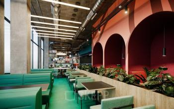 Modern office space rental at Nordbahnstraße 47 in 1020 Vienna Leopoldstadt with green booths and vibrant design accents.