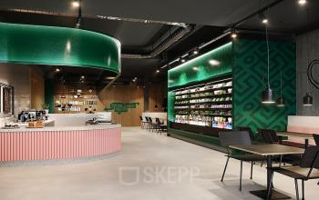 Modern and stylish office space rental at Nordbahnstraße 47, 1020 Vienna Leopoldstadt, featuring a vibrant lounge area with a coffee bar.