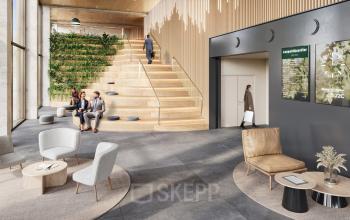 Moderner Eingangsbereich in einem Bürogebäude an der Obere Donaustraße 23-29, 1020 Wien, mit Sitzgelegenheiten und Treppen. Zwei Personen führen ein Gespräch. Perfekt für büroraum mieten.