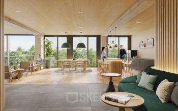 Moderne Bürofläche in der Oberen Donaustraße 23-29, 1020 Wien Leopoldstadt, mit hellen Holzelementen und stilvoller Einrichtung. Personen diskutieren aktiv an einem Tisch.