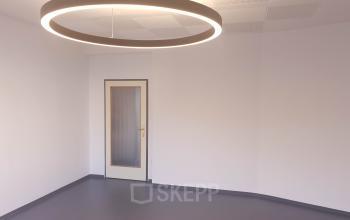 Sleek office space rental at Mittersteig 10, 1050 Vienna Margareten, featuring a modern light fixture and clean design.