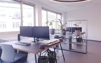 A bright, well-lit office space at Mittersteig 10, 1050 Vienna Margareten with modern desks and computers, ideal for those looking to rent office space.