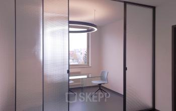 Well-lit office space rental at Mittersteig 10 in 1050 Vienna Margareten with a modern design and comfortable chair.