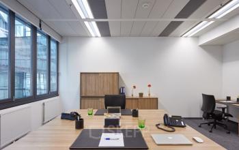 Modern office space rental at Am Euro Platz 2, 1120 Vienna Meidling with a well-equipped desk, comfortable seating, and ample natural light.