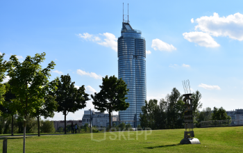 Modern office space rental at Handelskai 94-96, 1200 Vienna (Brigittenau), with clear skies and surrounding greenery.