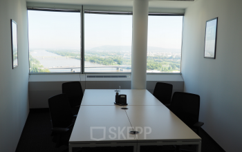Bright and modern office space rental at Handelskai 94-96, 1200 Vienna (Brigittenau), offering a scenic river view and a professional meeting environment.