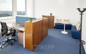Modern office space rental at Floridsdorfer Hauptstraße 1, Vienna with desks, chairs, storage units, and a lounge area.