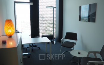 Modern office space rental at Donau-City-Straße 7, 1220 Vienna Donaustadt, with a well-lit desk, comfortable seating, and contemporary decor.