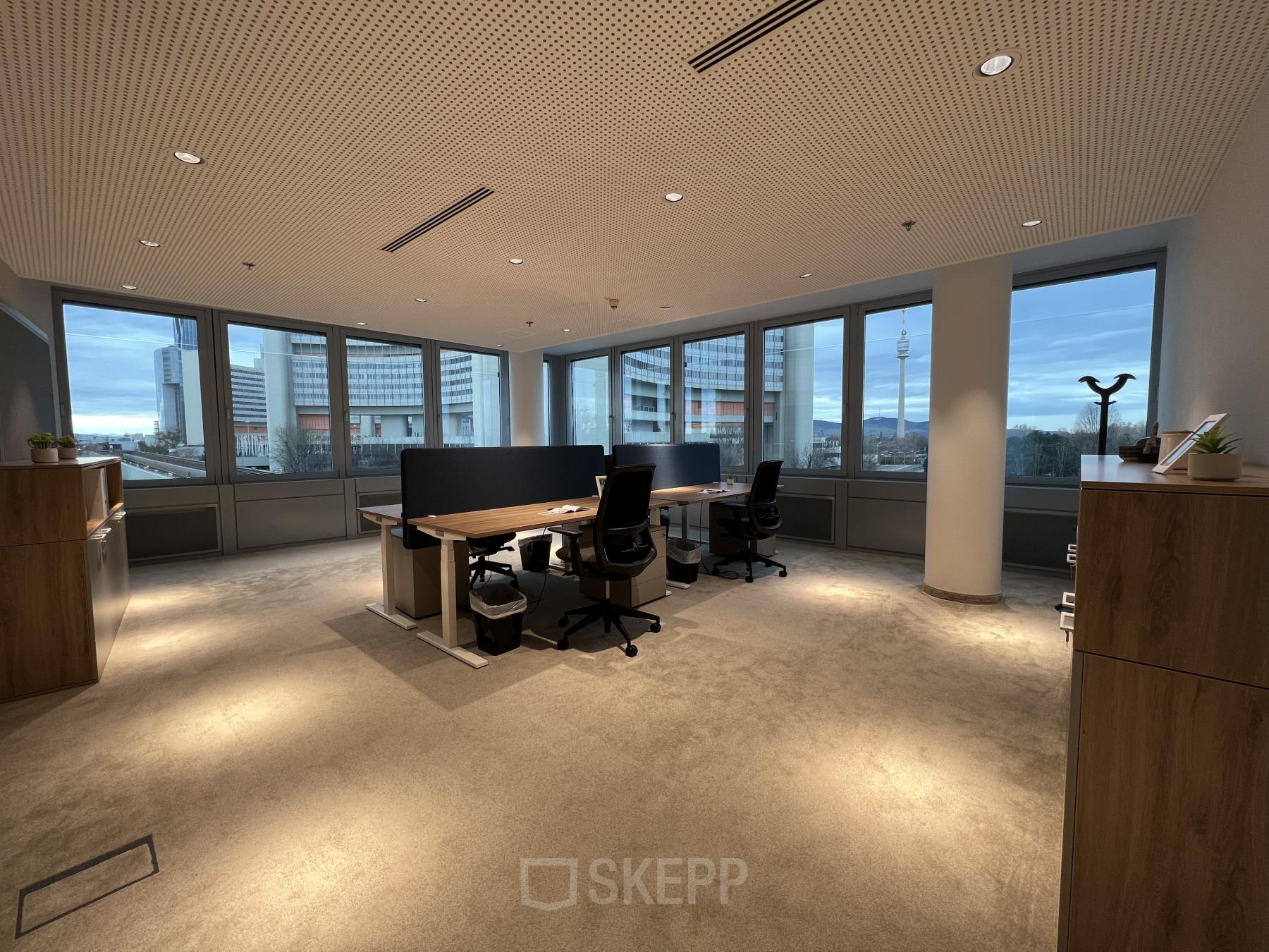 Spacious office to rent at Wagramer Straße 19, 1220 Vienna with large windows, modern desks, and ergonomic chairs.