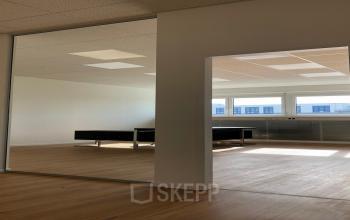 Modern, well-lit office space rental at IZ NÖ Süd Straße 3, 2351 Vienna Neudorf, with large windows and a minimalist design.
