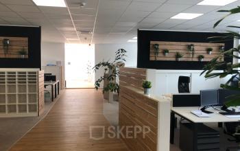 Modern office space rental at IZ NÖ Süd Straße 3, 2351 Vienna (Neudorf), featuring well-lit areas and contemporary wooden furnishings.