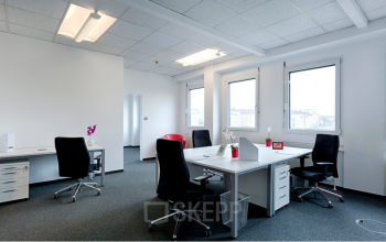 Bright, contemporary office space rental at Ricoweg 32 in 2351 Vienna (Neudorf) with white desks, red chairs, and ample natural light.