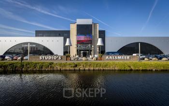 Exterior view of office building located at van Cleeffkade 15, Aalsmeer, featuring ample parking space and a modern design.