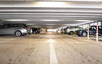 Parking garage area at van Cleeffkade 15 in Aalsmeer, featuring multiple cars in designated parking spaces.