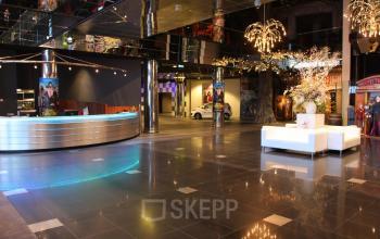 Spacious and modern office reception at van Cleeffkade 15, Aalsmeer, featuring sleek furnishings and contemporary lighting, ideal for office space rental.