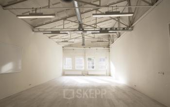 Spacious office space with high ceilings and large windows at van Cleeffkade 15, Aalsmeer. Available for office space rental.