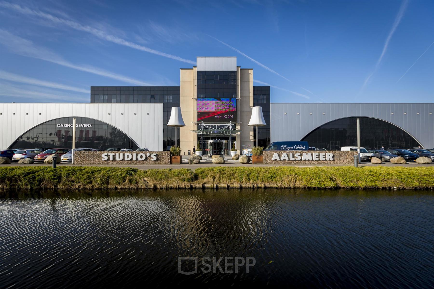 Exterior view of office building located at van Cleeffkade 15, Aalsmeer, featuring ample parking space and a modern design.