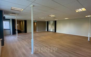 Interior view of unfurnished office space at Hollandse Kade 38, Abcoude, featuring a wooden floor and white walls, ideal for office space rental.