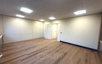 Unfurnished office space at Hollandse Kade 38, Abcoude, showcasing bright lighting and wooden flooring, available for rent.