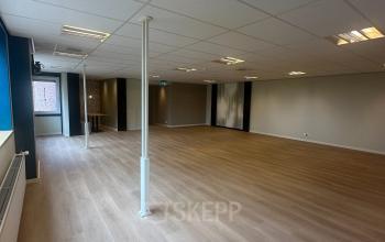 Spacious unfurnished office interior at Hollandse Kade 38, Abcoude, featuring wooden flooring and ceiling lights, ideal for those looking to rent office space.