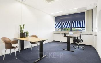 Modern office space rental at Markerkant 1310, Almere Stad, with desks, chairs, and a vibrant window view.