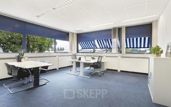 Spacious and well-lit office space rental at Markerkant 1310, Almere Stad with desks, chairs, and large windows offering plenty of natural light.