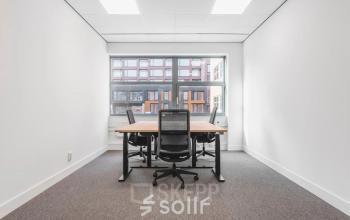 Bright office space at Veluwezoom 15, Almere Stad, featuring a desk and chairs, ideal for office space rental.
