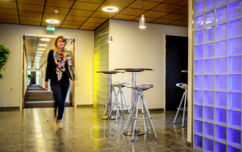 Modern office at Leidse Schouw 2, Alphen aan den Rijn, featuring sleek furnishings and vibrant lighting, perfect for office space rental.