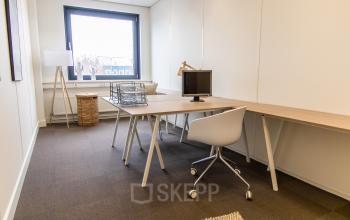 Modern office space rental at Europalaan 16 in Alphen aan den Rijn featuring a furnished workspace with a desk, chair, and monitor, ideal for businesses seeking an office to rent.