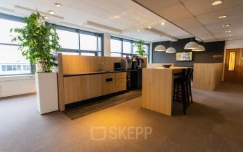 Well-equipped kitchenette in an office space rental at Europalaan 16, Alphen aan den Rijn, with modern amenities and a high stool seating area.