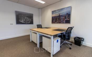 Office space at Europalaan 16, Alphen aan den Rijn, featuring two desks with office chairs and wall art. Ideal for those looking to rent office space in a professional setting.