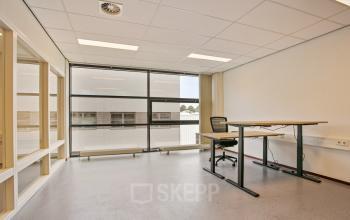 Bright, minimalist office space at Astronaut 28, Amersfoort Calveen, perfect for office space rental with large windows and modern furnishings.
