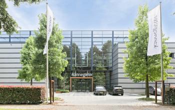 Exterior view of a modern office building located at Astronaut 28, Amersfoort Calveen, showcasing sleek architecture with large windows and adjacent parking, ideal for business professionals looking for rent office space.