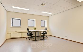 Bright office space at Astronaut 28, Amersfoort Calveen, featuring a minimalistic design with two desks and chairs under ceiling lights, ideal for office space rental.