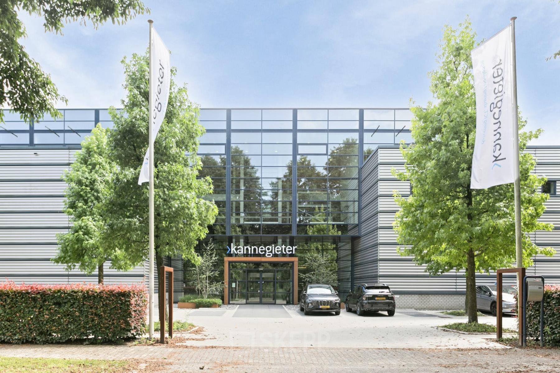 Exterior view of a modern office building located at Astronaut 28, Amersfoort Calveen, showcasing sleek architecture with large windows and adjacent parking, ideal for business professionals looking for rent office space.