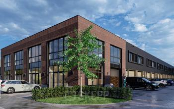 Exterior view of office building at Spaceshuttle 18C, Amersfoort Calveen, featuring modern brick facade and large windows ideal for office space rental. The parking lot includes several cars and a tree.