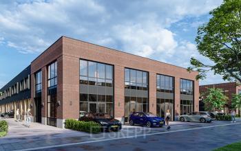 Exterior view of Spaceshuttle 18C office building in Amersfoort Calveen, showcasing modern architecture and ample parking. Ideal for those seeking office space rental. The building features large windows and contemporary design.