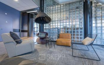 Stylish office to rent at Maanlander 47, Amersfoort Calveen, featuring cozy lounge seating and modern design elements for office space rental.