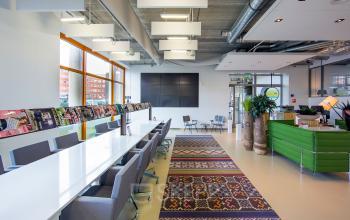 Spacious and well-lit office space rental at Piet Mondriaanplein 13-31, Amersfoort Centraal Station, with modern furniture and vibrant decor accents.