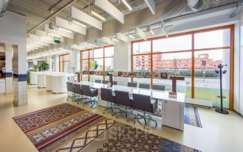 Modern office space rental at Piet Mondriaanplein 13-31, Amersfoort Centraal Station, with a vibrant, well-lit workspace and colorful accents.