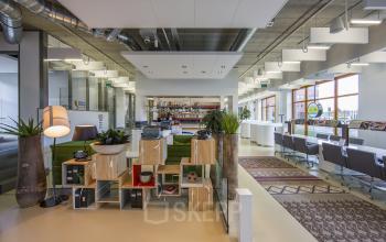 Modern office space rental at Piet Mondriaanplein 13-31, Amersfoort Centraal Station with well-lit work areas and cozy seating options.