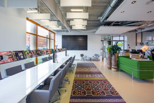 Spacious and well-lit office space rental at Piet Mondriaanplein 13-31, Amersfoort Centraal Station, with modern furniture and vibrant decor accents.