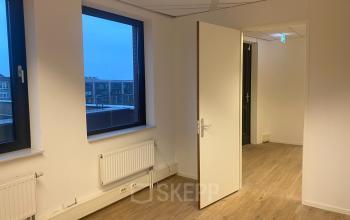 Spacious office located at Van Asch van Wijckstraat 2-4 in Amersfoort Centrum with modern wooden flooring and large windows. Ideal for office space rental.