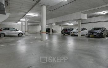A spacious underground parking area at Van Asch van Wijckstraat 2-4, Amersfoort Centrum, ideal for tenants of the office space rental, featuring well-marked parking spots and a clean, secure environment.