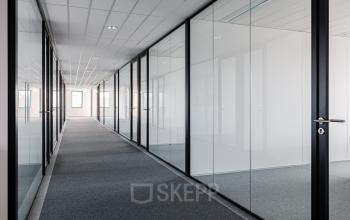 Modern office corridor at Stadsring 201, Amersfoort Centrum, showcasing sleek glass partitions ideal for office space rental opportunities.