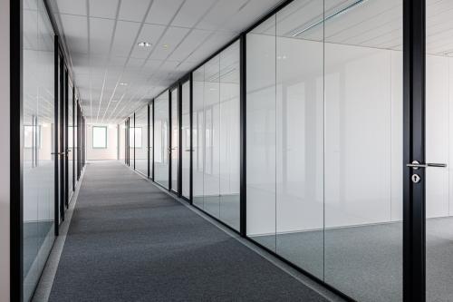 Modern office corridor at Stadsring 201, Amersfoort Centrum, showcasing sleek glass partitions ideal for office space rental opportunities.