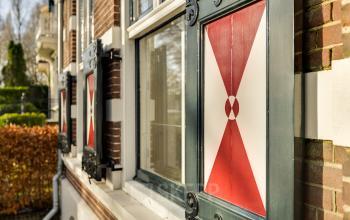 Exterior view of office building at Stadsring 248-250, Amersfoort Centrum, featuring classic Dutch architecture with red and white window shutters, ideal for office space rental.